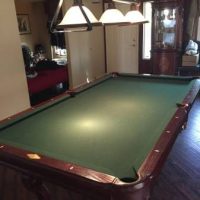 Pool Table with Cues, Rack, Pool Balls, and Lighting Fixture